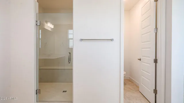 a bathroom with a glass shower door