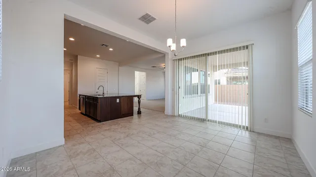 a view of an empty room with a chandelier