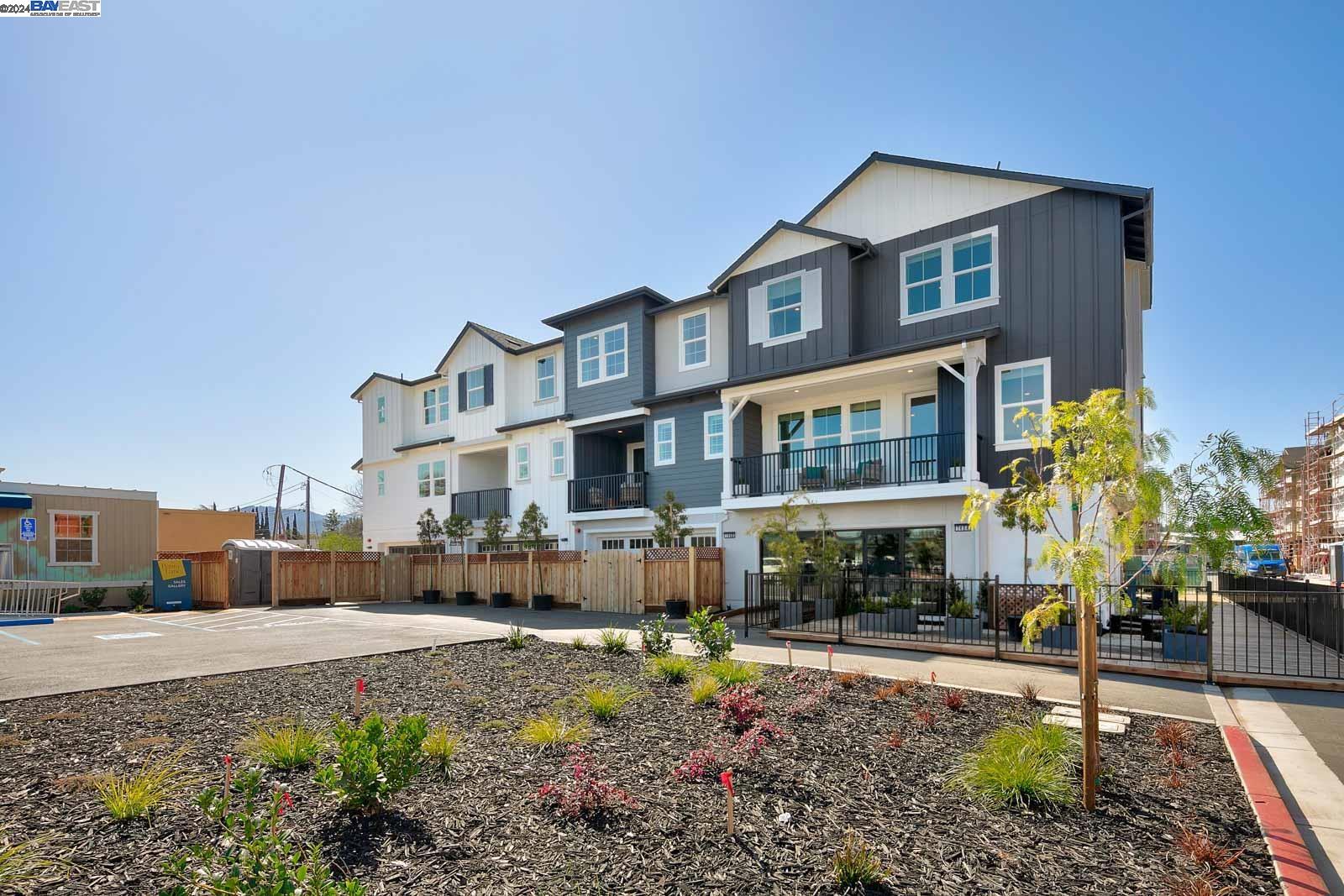 a front view of a house with a yard and seating space