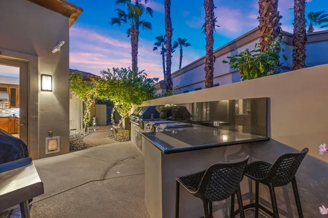 a bathroom with a granite countertop sink toilet a mirror a vanity and shower