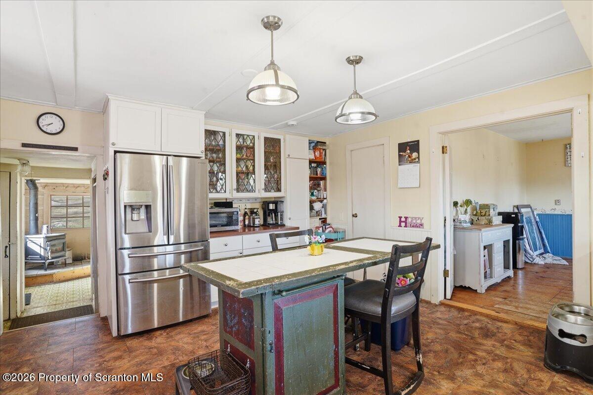 519 Sutton Road New Milford, PA 18834 - Photo 17 of 80 a kitchen with stainless steel appliances granite countertop a refrigerator a stove a sink a dining table and chairs with wooden floor
