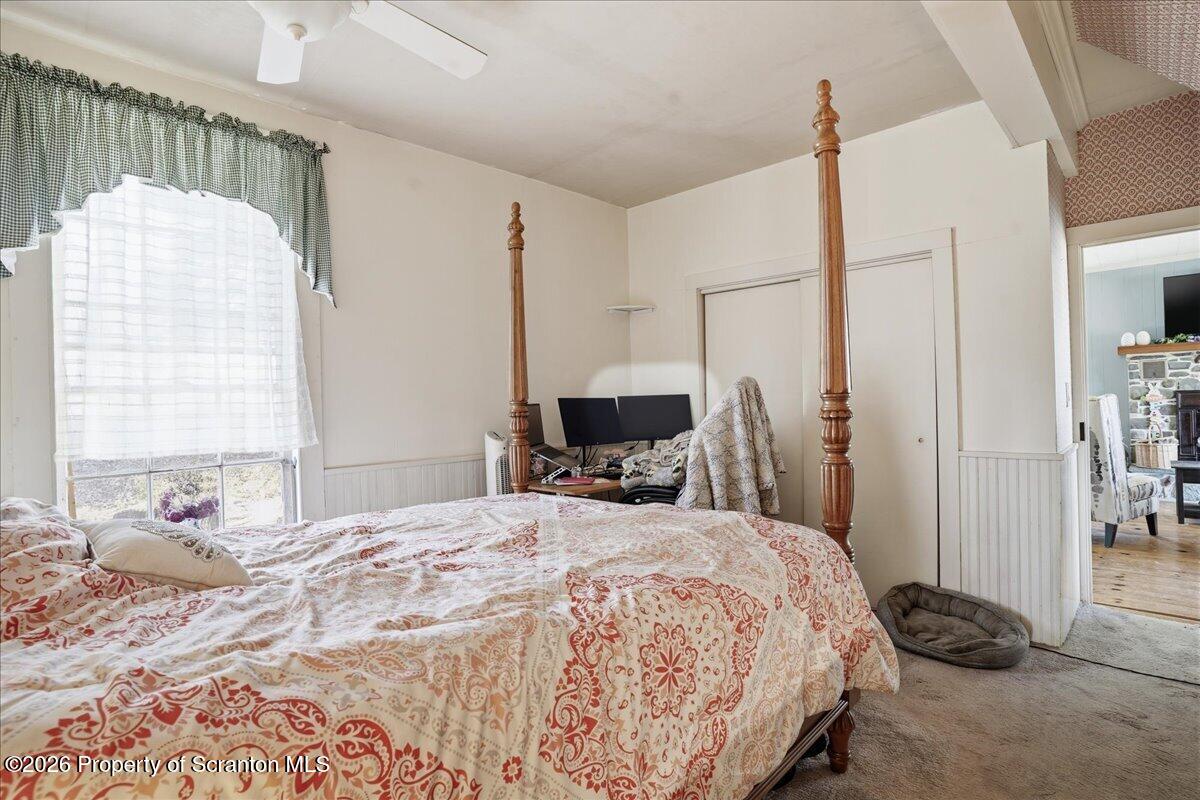 519 Sutton Road New Milford, PA 18834 - Photo 23 of 80 a bedroom with a bed large window and a mirror