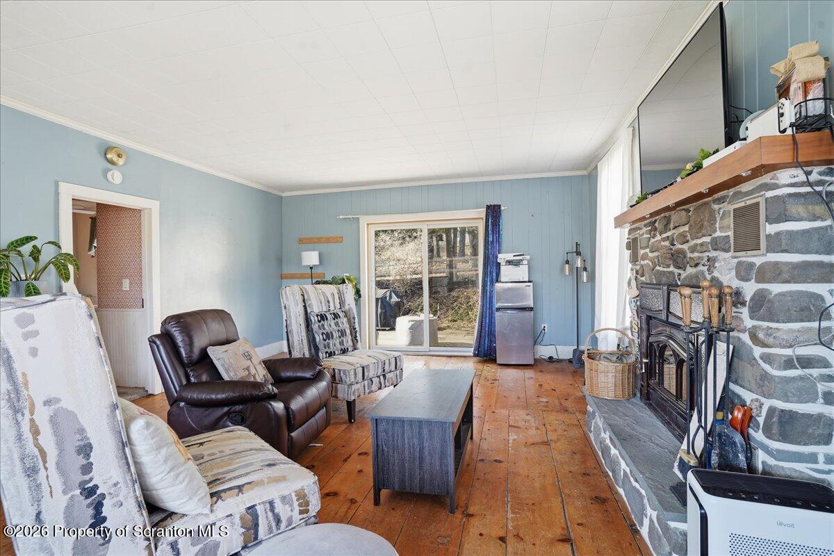 519 Sutton Road New Milford, PA 18834 - Photo 27 of 80 a living room with furniture and a fireplace