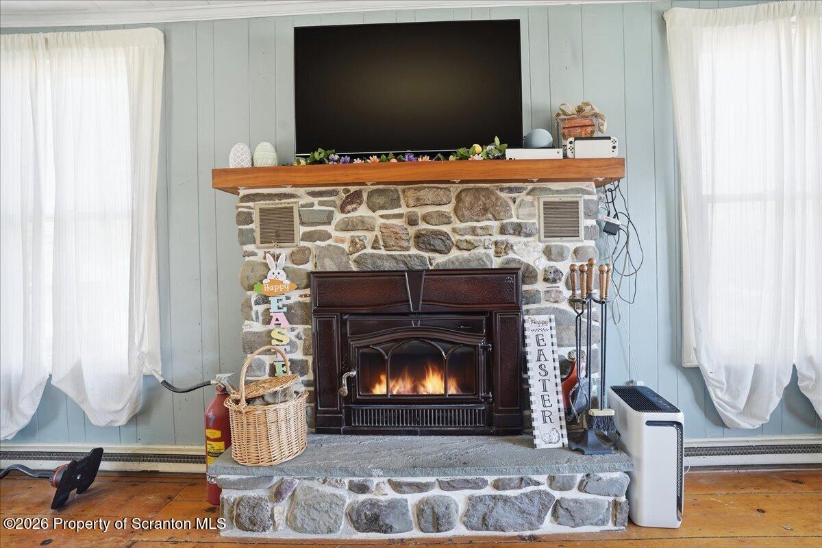 519 Sutton Road New Milford, PA 18834 - Photo 29 of 80 a living room with furniture and a fireplace
