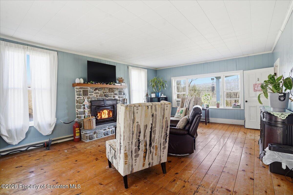 519 Sutton Road New Milford, PA 18834 - Photo 30 of 80 a living room with furniture a flat screen tv and a fireplace