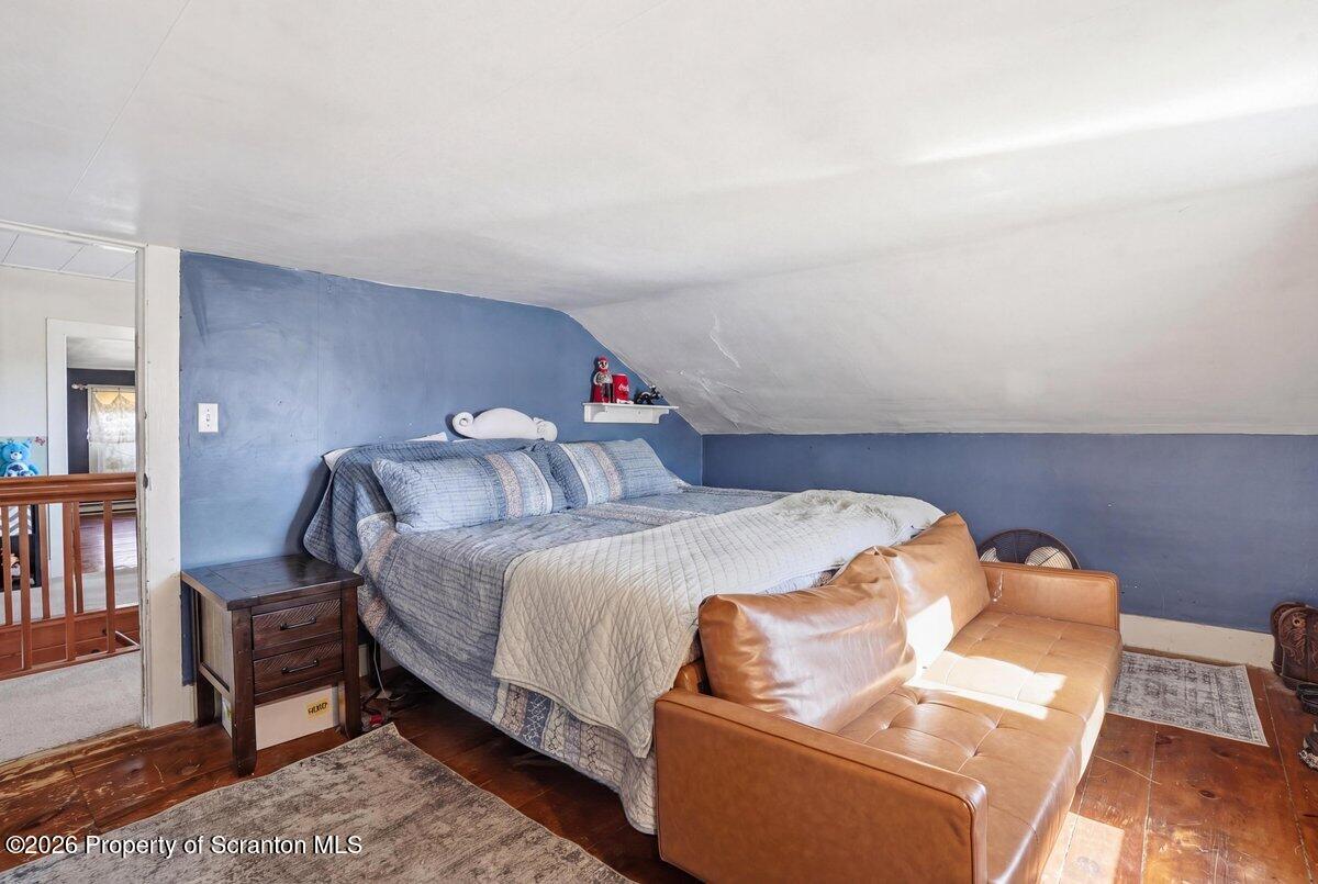 519 Sutton Road New Milford, PA 18834 - Photo 34 of 80 a bedroom with a bed and wooden floor