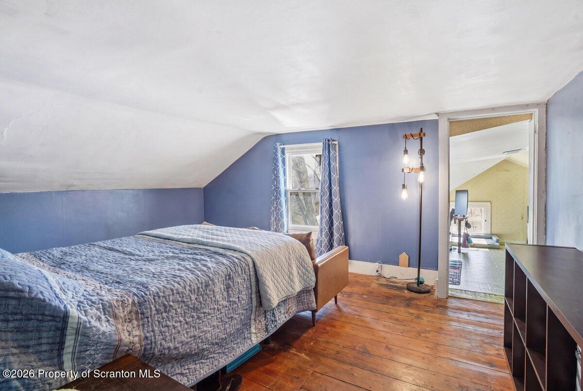 519 Sutton Road New Milford, PA 18834 - Photo 35 of 80 a bedroom with a bed and wooden floor