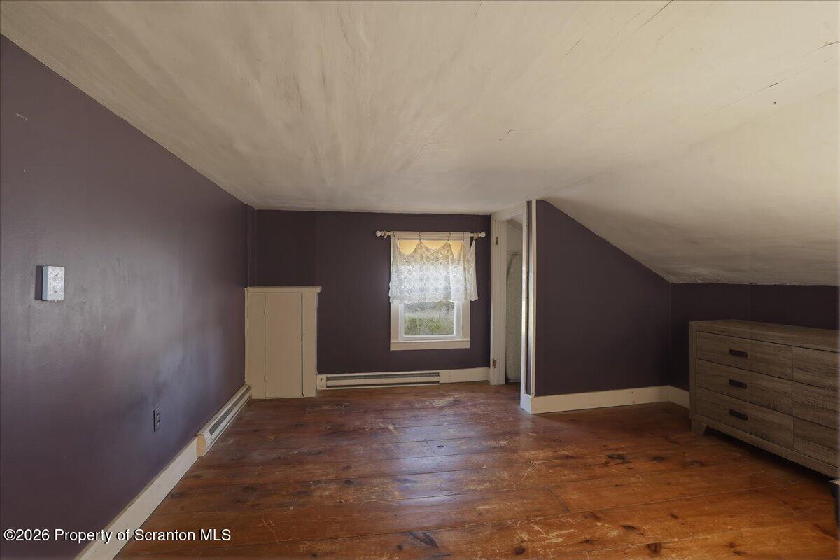 519 Sutton Road New Milford, PA 18834 - Photo 41 of 80 a view of an empty room with wooden floor and a window