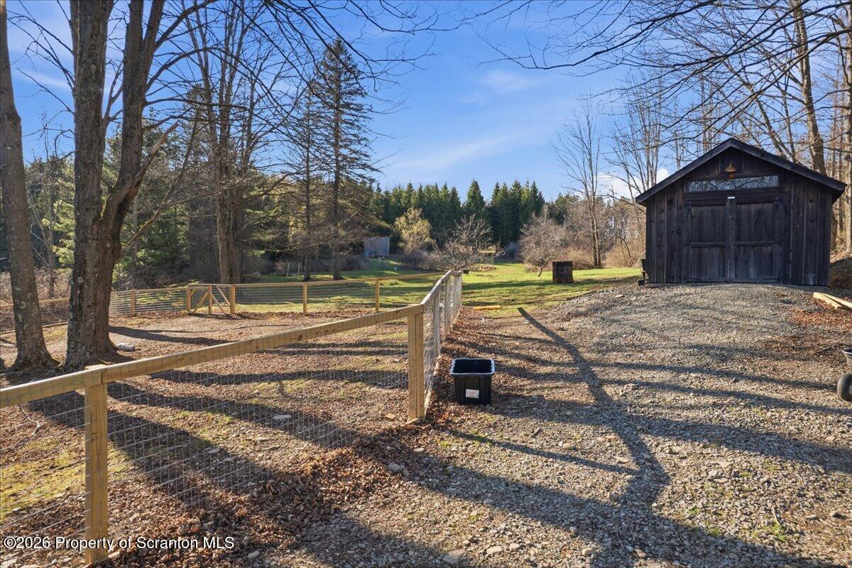 519 Sutton Road New Milford, PA 18834 - Photo 47 of 80 a view of backyard with wooden fence and large trees