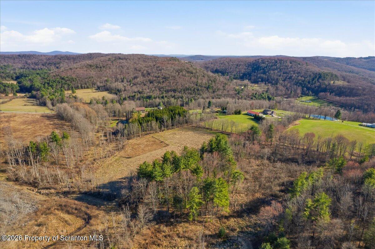 519 Sutton Road New Milford, PA 18834 - Photo 64 of 80 a view of a lake with mountains in the background