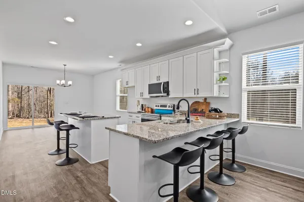 a kitchen with sink and chairs