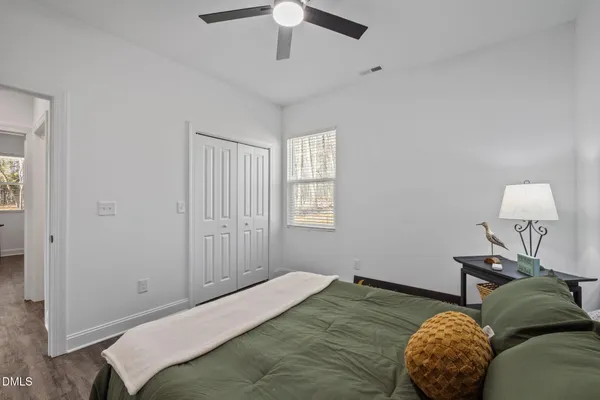 a bedroom with two beds and lamp