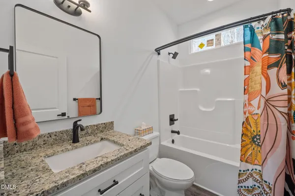 a bathroom with a sink toilet and mirror