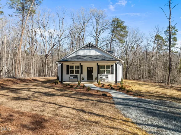 a front view of house with yard space and trees around