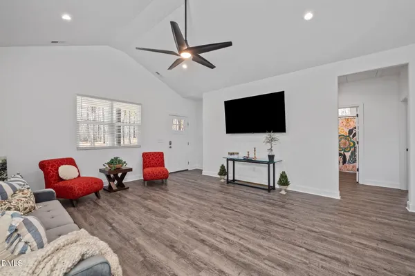 a living room with furniture and a wooden floor