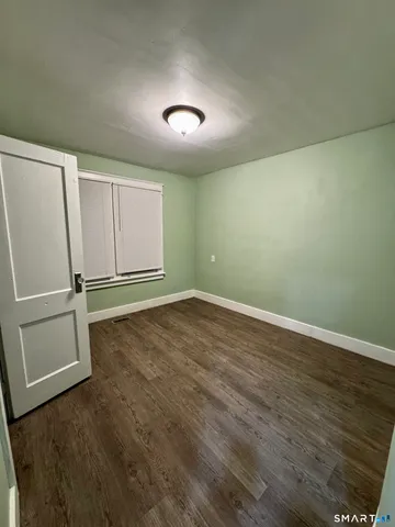 an empty room with wooden floor