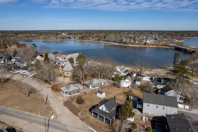an aerial view of a house with a lake view