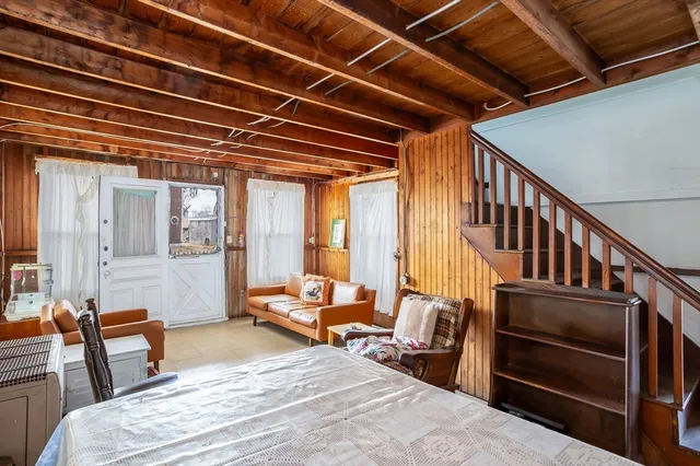 a bedroom with furniture staircase and windows