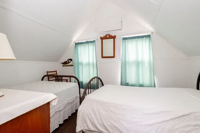 a bedroom with a bed and a large mirror