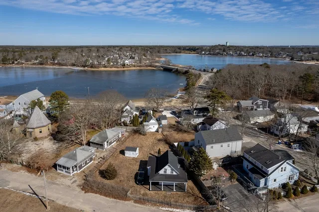 an aerial view of a house with a lake view