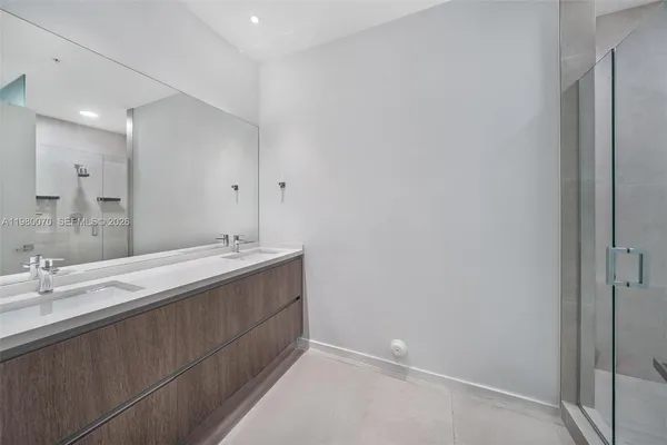 a bathroom with a double vanity sink and a mirror