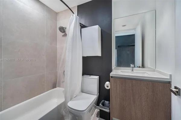 a bathroom with a toilet a sink and bathtub