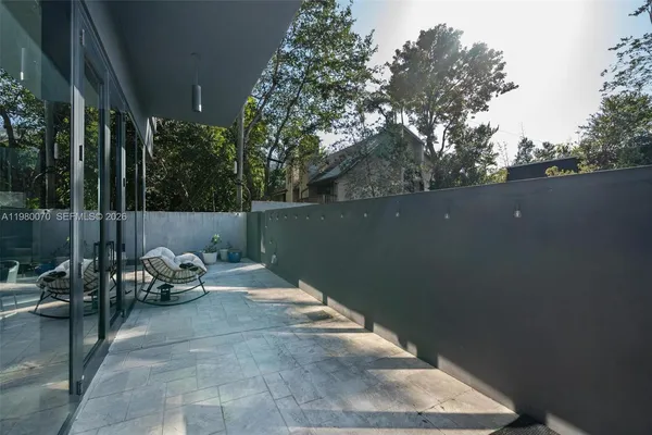 a view of backyard with sitting area