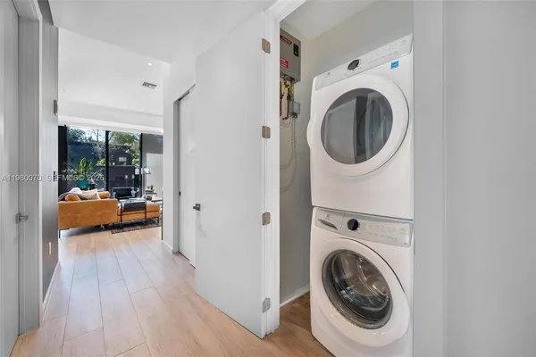 a view of a bedroom with washer and dryer