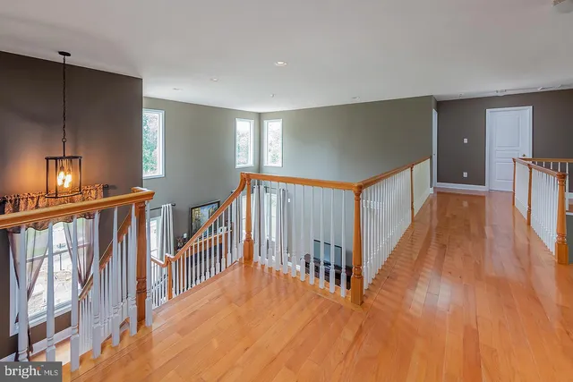 a view of a hallway with a wooden floor and entryway