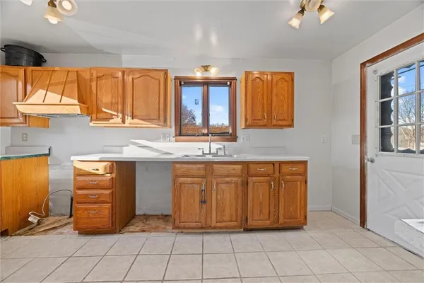 a view of kitchen with granite countertop cabinets