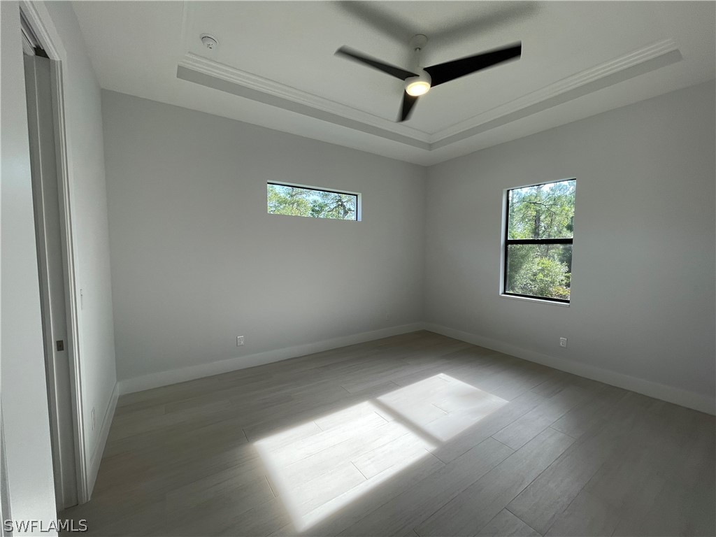 603 West 9th Street Lehigh Acres, FL 33972 - Photo 13 of 14 an empty room with windows