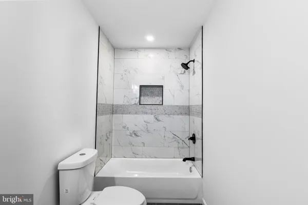 a bathroom with a toilet and a bathtub