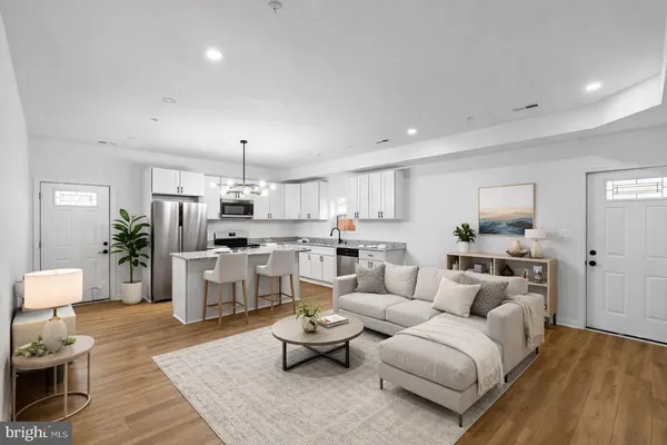 a living room with furniture and kitchen view