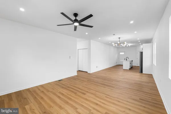 a big room with wooden floor and windows