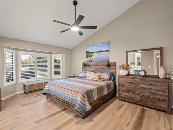 a bedroom with a large bed and a chandelier