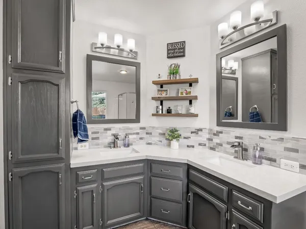 a bathroom with a sink vanity and a mirror
