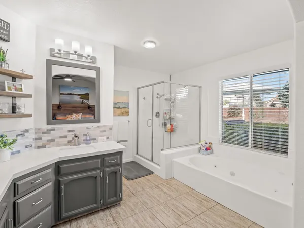 a spacious bathroom with double vanity a large mirror a bathtub and a shower