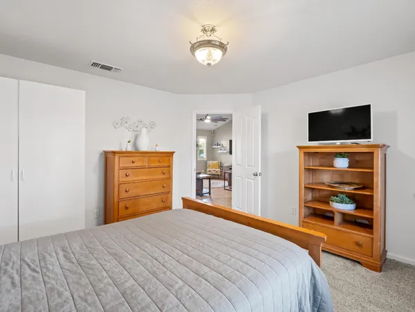 a bedroom with a bed and a television