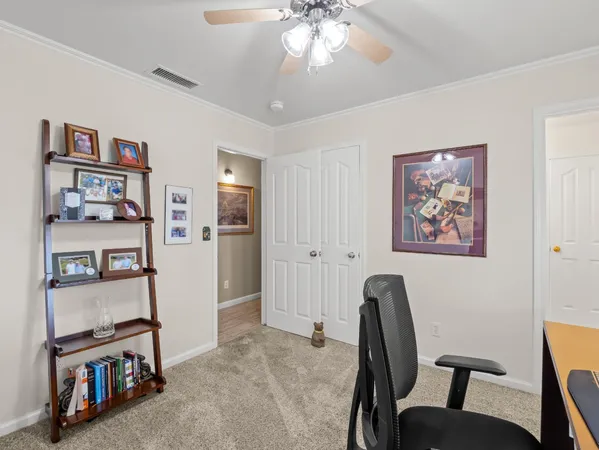 a view of a dining room with furniture and a book shelf