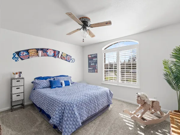 a bedroom with a bed and a window