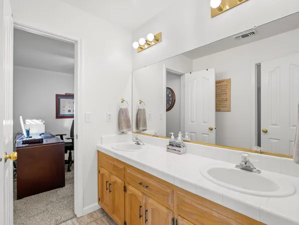 a bathroom with a double vanity sink and a mirror