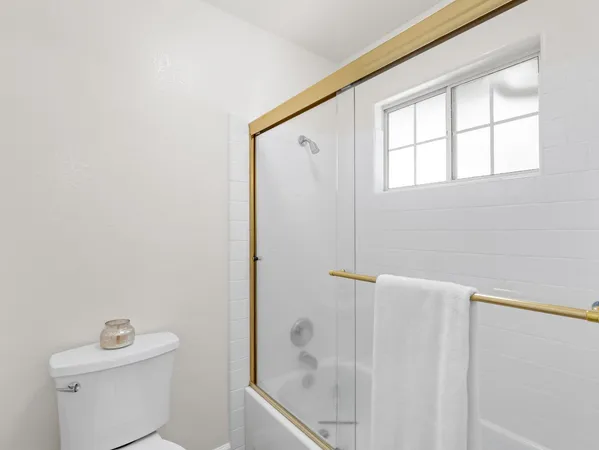 a bathroom with a shower and a toilet