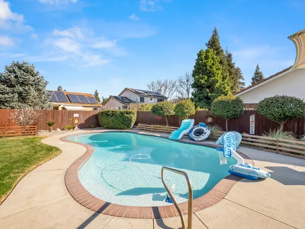 a backyard of a house with table and chairs