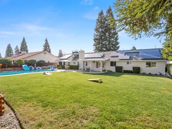 a aerial view of a house with swimming pool yard and outdoor seating