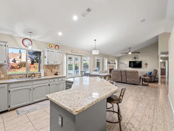 a large kitchen with a table and chairs in it