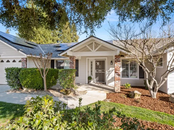 a front view of a house with garden