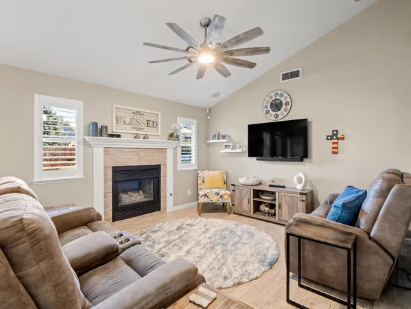 a living room with furniture flat screen tv and a fireplace