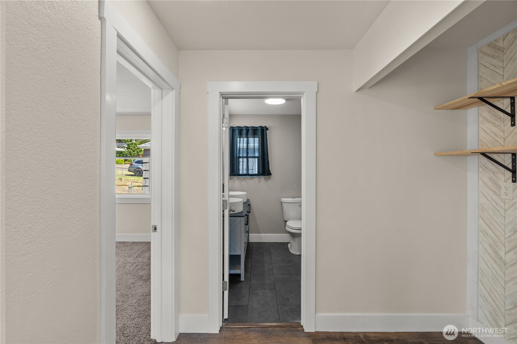 2736 Riverview Drive Aberdeen, WA 98520 - Photo 13 of 40 a view of a hallway with wooden floor and a bathroom