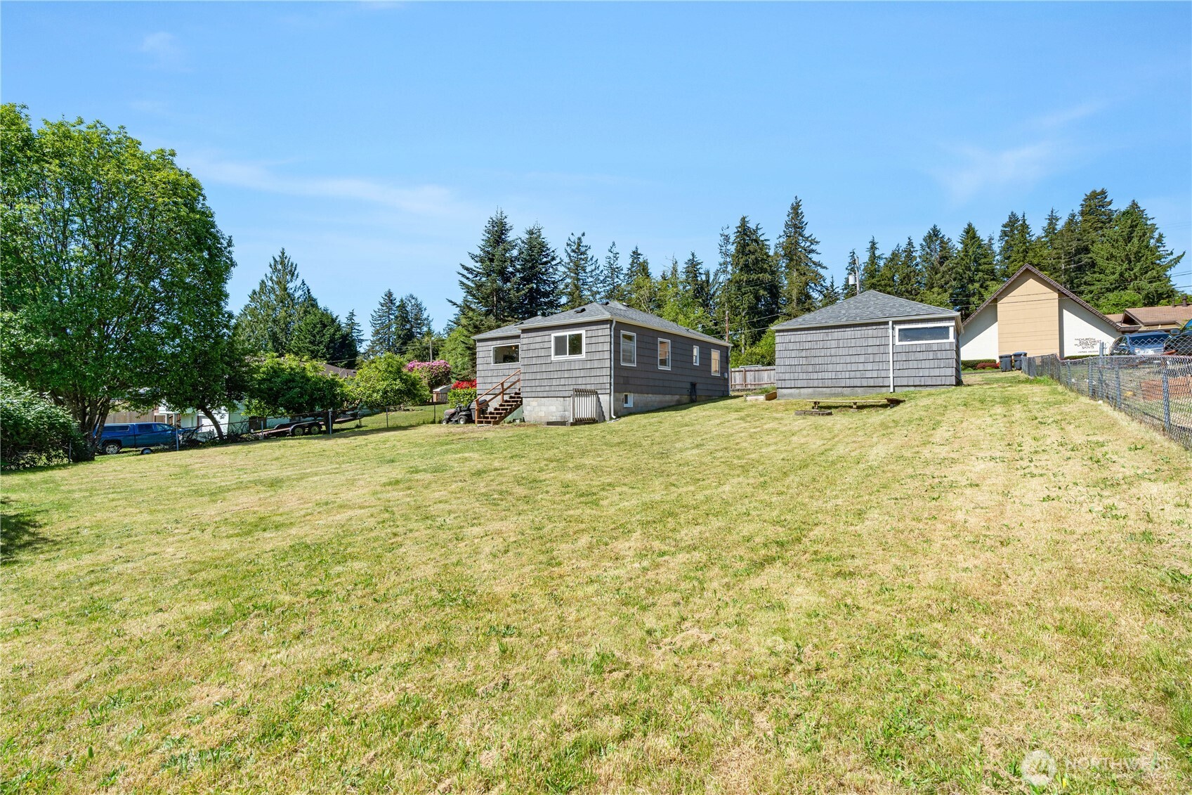 2736 Riverview Drive Aberdeen, WA 98520 - Photo 31 of 40 a yellow house with a big yard and large trees
