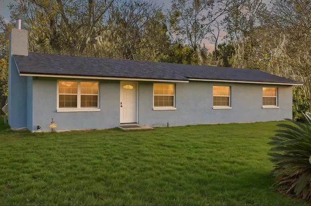 a house that has a tree in front of it